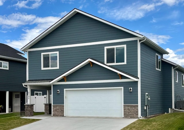 2195 Black Bird Ln, Kalispell, MT 59901 - craftsman-style house with stone siding, driveway, and an attached garage
