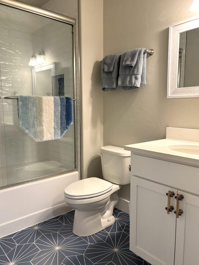 2195 Black Bird Ln, Kalispell, MT 59901 - bathroom featuring vanity, combined bath / shower with glass door, tile patterned floors, and a textured wall