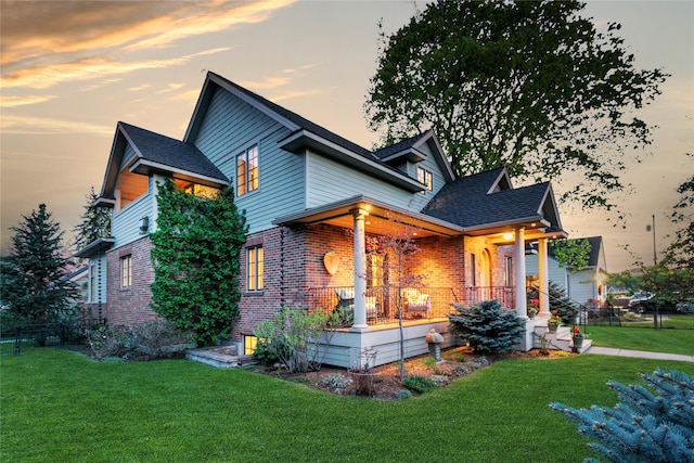 145 E Beckwith Ave, Missoula, MT 59801 - view of front facade featuring brick siding, a porch, and roof with shingles
