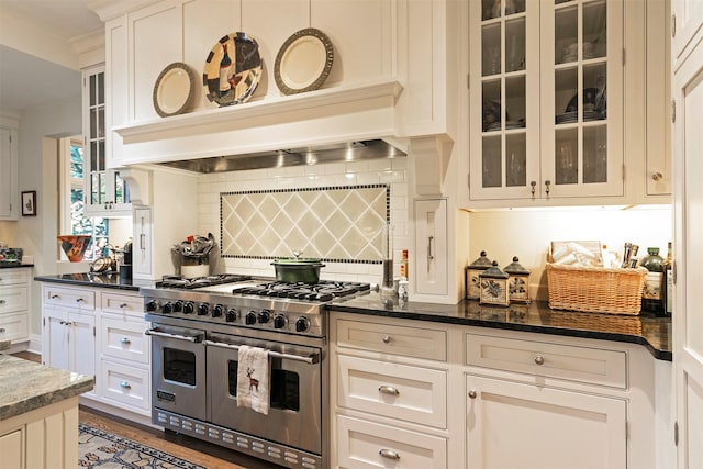 145 E Beckwith Ave, Missoula, MT 59801 - kitchen featuring double oven range, tasteful backsplash, glass insert cabinets, and dark stone counters