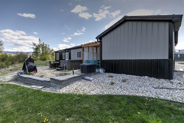 4358 Charlotte Way, Stevensville, MT 59870 - rear view of house with a hot tub and a yard