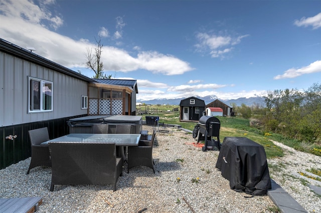 4358 Charlotte Way, Stevensville, MT 59870 - view of yard featuring outdoor dining area, a storage unit, and a mountain view