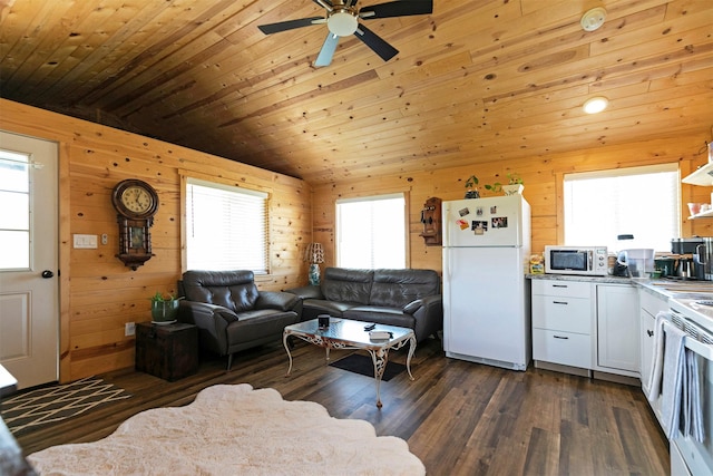 4358 Charlotte Way, Stevensville, MT 59870 - living area featuring a ceiling fan, wood ceiling, dark wood finished floors, wood walls, and lofted ceiling