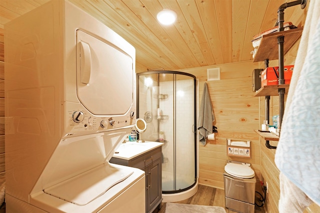 4358 Charlotte Way, Stevensville, MT 59870 - laundry room with stacked washing machine and dryer, wood ceiling, light wood-style flooring, and wood walls