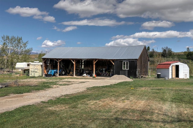 4358 Charlotte Way, Stevensville, MT 59870 - view of front of house with a front lawn, a storage unit, a pole building, and a metal roof