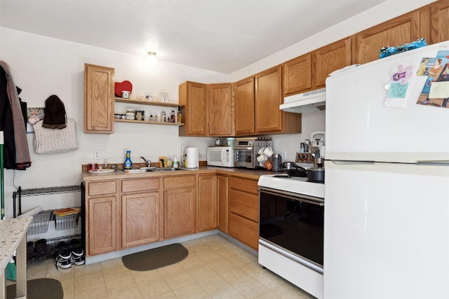 kitchen featuring white appliances, under cabinet range hood, a sink, open shelves, and brown cabinetry