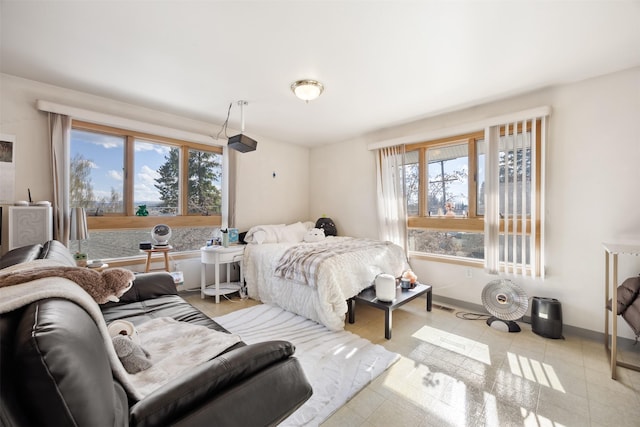 bedroom featuring multiple windows and baseboards