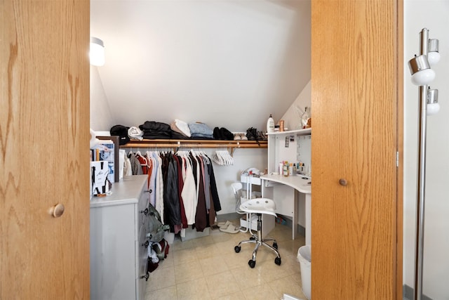 walk in closet featuring vaulted ceiling
