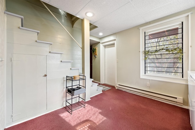 basement featuring a baseboard radiator, carpet, stairway, and recessed lighting