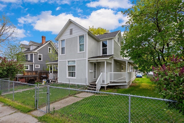 29 3rd Ave E, Kalispell, MT 59901 - view of front facade with a porch, a gate, a fenced front yard, and a shingled roof