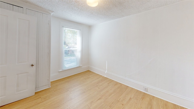 29 3rd Ave E, Kalispell, MT 59901 - empty room with a textured ceiling and light wood-style flooring