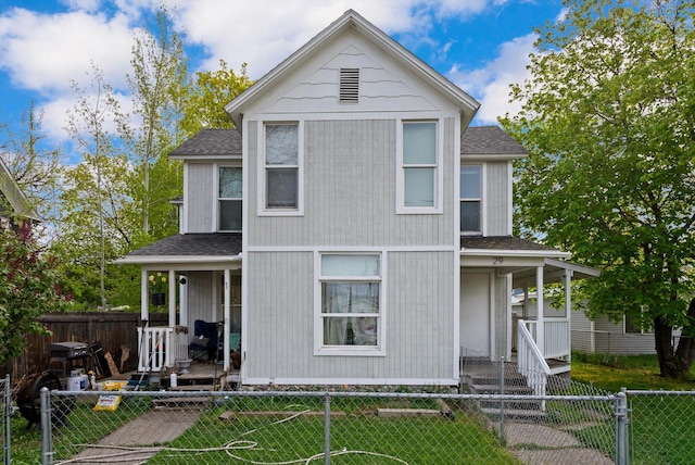 29 3rd Ave E, Kalispell, MT 59901 - view of front of house with covered porch, a fenced front yard, and roof with shingles