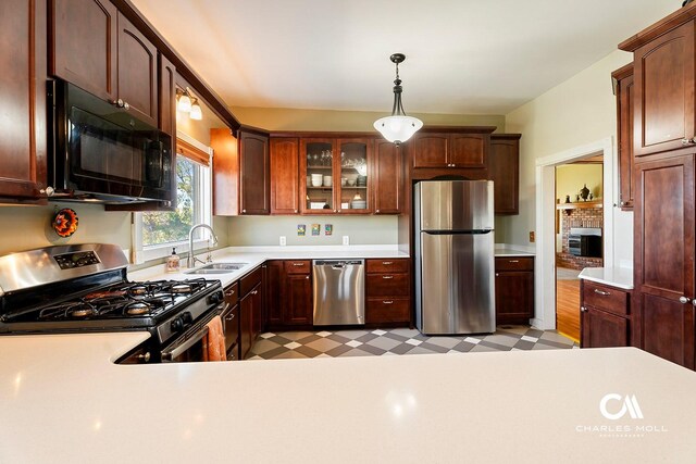 202 Blake St, Helena, MT 59601 - kitchen featuring stainless steel appliances, a sink, light countertops, pendant lighting, and light flooring