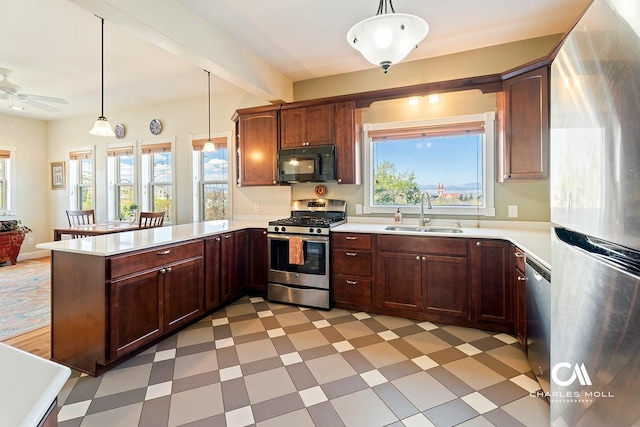 202 Blake St, Helena, MT 59601 - kitchen with appliances with stainless steel finishes, a sink, light flooring, a peninsula, and plenty of natural light