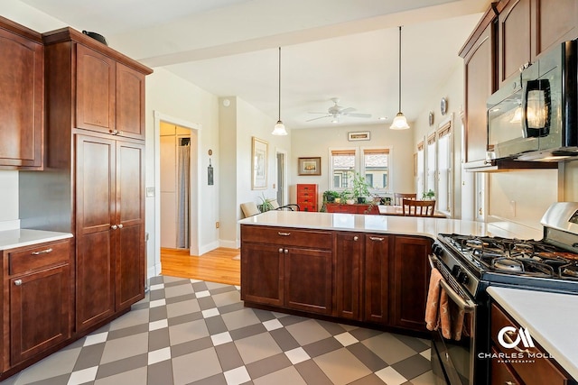 202 Blake St, Helena, MT 59601 - kitchen featuring gas stove, black microwave, light flooring, light countertops, and a peninsula