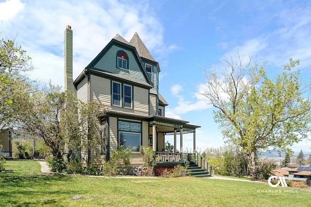 202 Blake St, Helena, MT 59601 - victorian-style house with covered porch, a front yard, and a chimney