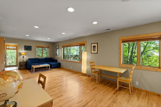 living room with light wood-style floors, baseboards, and recessed lighting