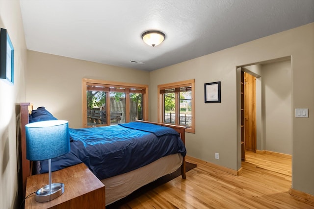 bedroom with wood finished floors and baseboards