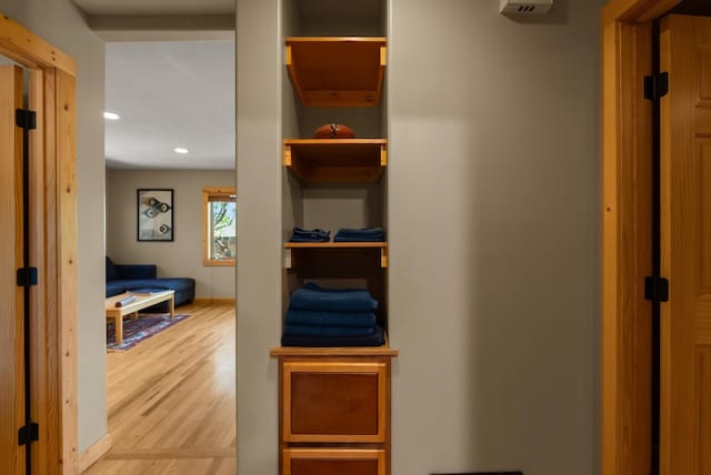 corridor with light wood-style floors and recessed lighting