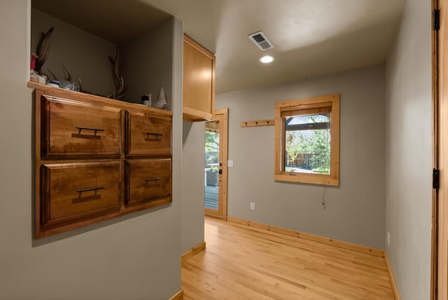 hall with light wood finished floors, recessed lighting, and baseboards