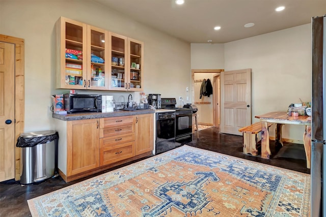 kitchen with black appliances, recessed lighting, a sink, glass insert cabinets, and light brown cabinets