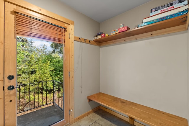 mudroom with light tile patterned floors and baseboards