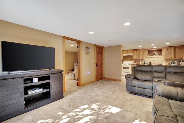 living area featuring recessed lighting and baseboards