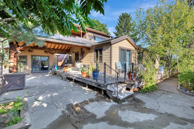 rear view of house with a patio area and a wooden deck