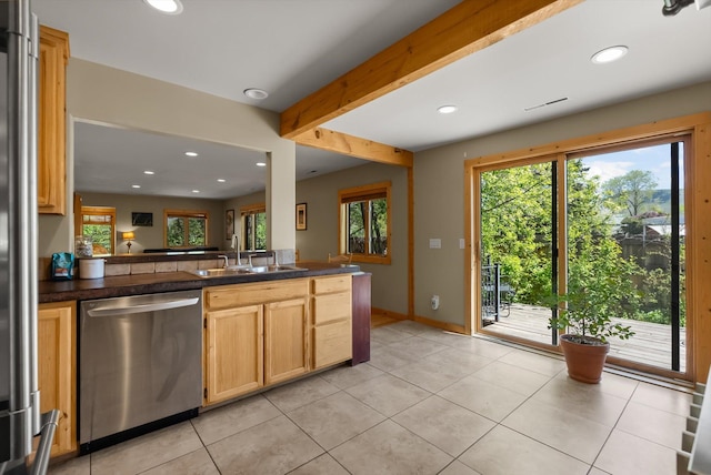 kitchen with dishwasher, a sink, dark countertops, recessed lighting, and light tile patterned flooring