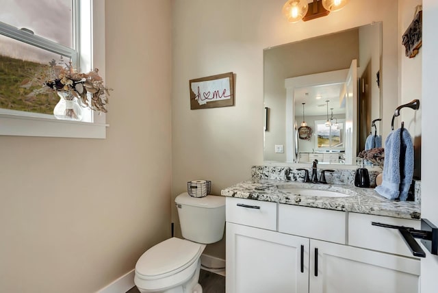 7047 Shaver Dr Unit B, Missoula, MT 59803 - bathroom with toilet, vanity, and baseboards