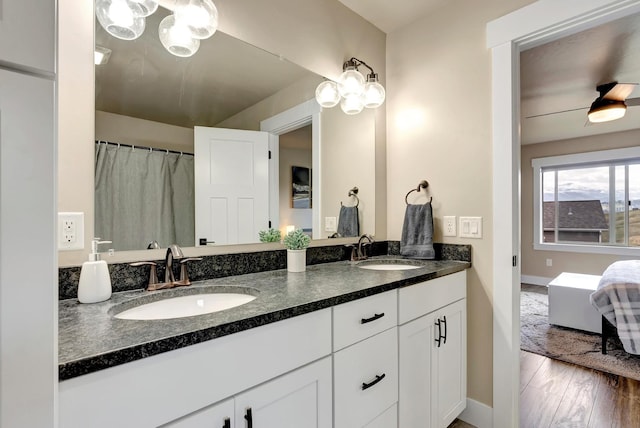 7047 Shaver Dr Unit B, Missoula, MT 59803 - bathroom featuring baseboards, double vanity, and a chandelier