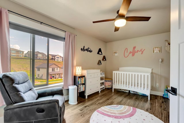 7047 Shaver Dr Unit B, Missoula, MT 59803 - bedroom featuring a nursery area, wood finished floors, ceiling fan, and baseboards