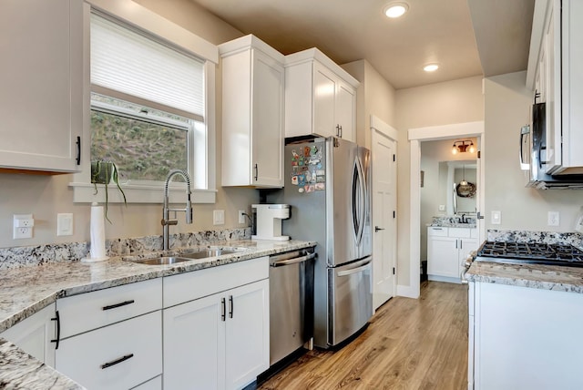 7047 Shaver Dr Unit B, Missoula, MT 59803 - kitchen featuring stainless steel appliances, a sink, white cabinetry, light wood-type flooring, and recessed lighting