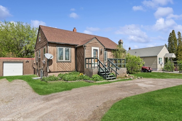 175 Two Mile Dr, Kalispell, MT 59901 - view of front facade with dirt driveway, a chimney, a front yard, and roof with shingles