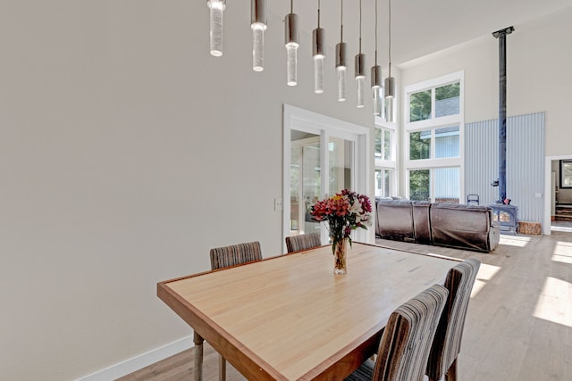 11327 Sleeman Ln, Lolo, MT 59847 - dining space with a towering ceiling, light wood-style floors, and baseboards