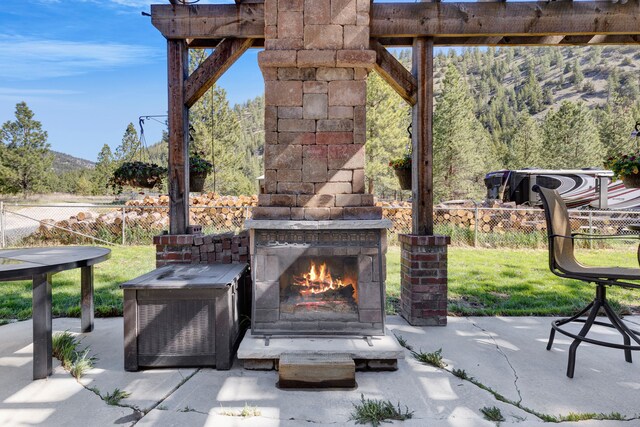 11327 Sleeman Ln, Lolo, MT 59847 - view of patio / terrace with an outdoor stone fireplace and fence