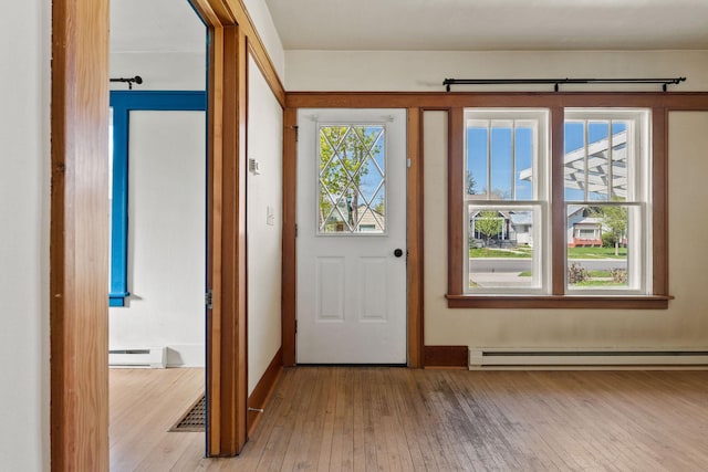427 Somers Ave, Whitefish, MT 59937 - foyer featuring baseboard heating, a baseboard heating unit, and hardwood / wood-style flooring
