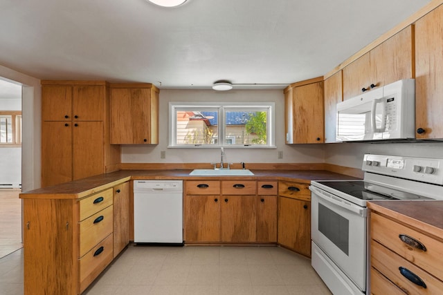 427 Somers Ave, Whitefish, MT 59937 - kitchen with white appliances, a peninsula, and light flooring