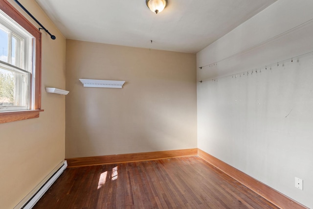 427 Somers Ave, Whitefish, MT 59937 - empty room featuring a baseboard heating unit and hardwood / wood-style floors