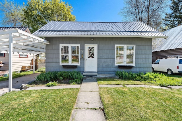 427 Somers Ave, Whitefish, MT 59937 - bungalow-style home with a carport, a front yard, and a metal roof