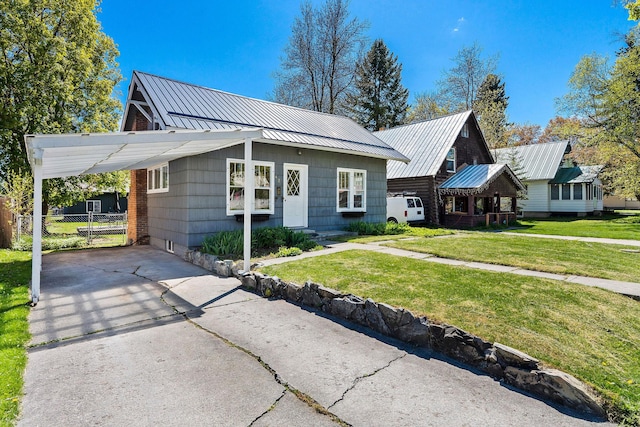 427 Somers Ave, Whitefish, MT 59937 - view of front facade featuring asphalt driveway, an attached carport, and a metal roof
