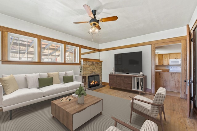 427 Somers Ave, Whitefish, MT 59937 - living room with hardwood / wood-style flooring, ceiling fan, and a brick fireplace