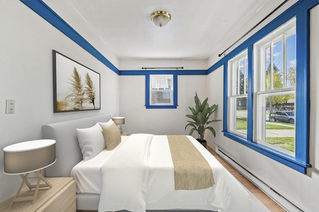 427 Somers Ave, Whitefish, MT 59937 - bedroom with a baseboard heating unit and wood finished floors