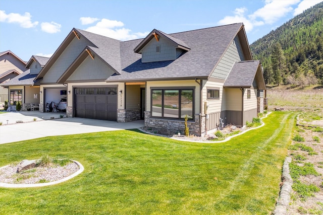 5237 Ginger Quill Rd Unit B, Missoula, MT 59802 - view of front of home with concrete driveway, stone siding, roof with shingles, and a front lawn