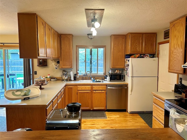 146 New Meadows Dr, Missoula, MT 59808 - kitchen with appliances with stainless steel finishes, light countertops, plenty of natural light, and a textured ceiling