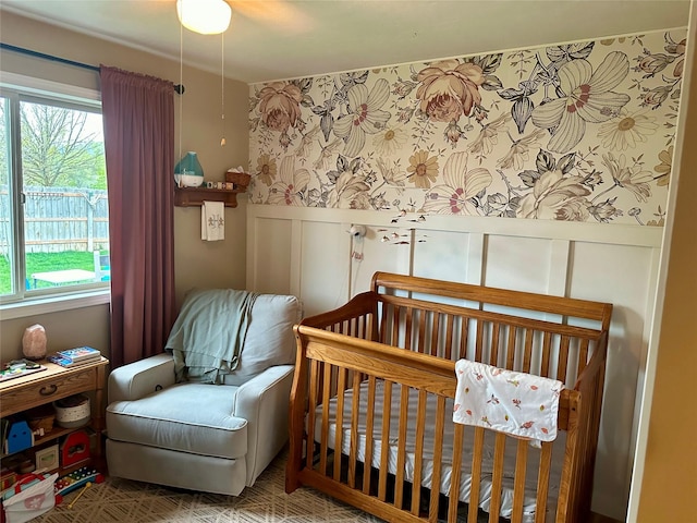 146 New Meadows Dr, Missoula, MT 59808 - bedroom featuring a decorative wall, multiple windows, wainscoting, and a nursery area