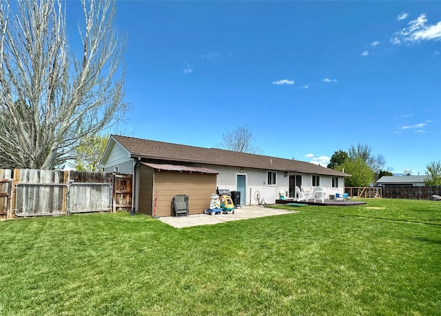146 New Meadows Dr, Missoula, MT 59808 - back of property with a fenced backyard, a patio area, a deck, a shingled roof, and a gate