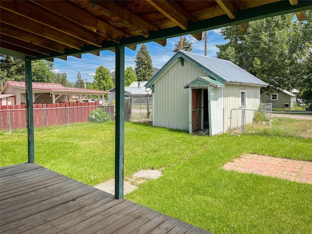 613 Minnesota Ave, Libby, MT 59923 - fenced backyard with a wooden deck and an outdoor structure