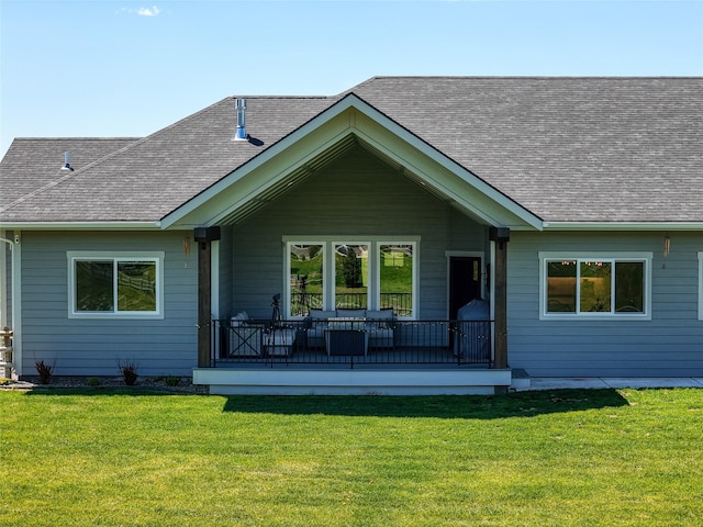 29 Elk Run Trl, Kalispell, MT 59901 - rear view of house featuring a yard, a shingled roof, and a porch