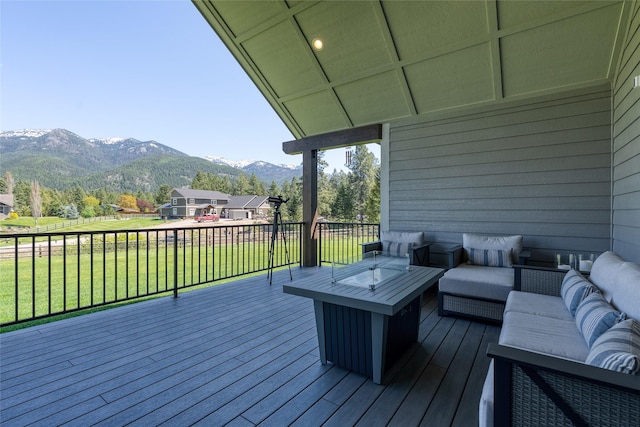 29 Elk Run Trl, Kalispell, MT 59901 - wooden terrace featuring an outdoor hangout area, a mountain view, and a lawn